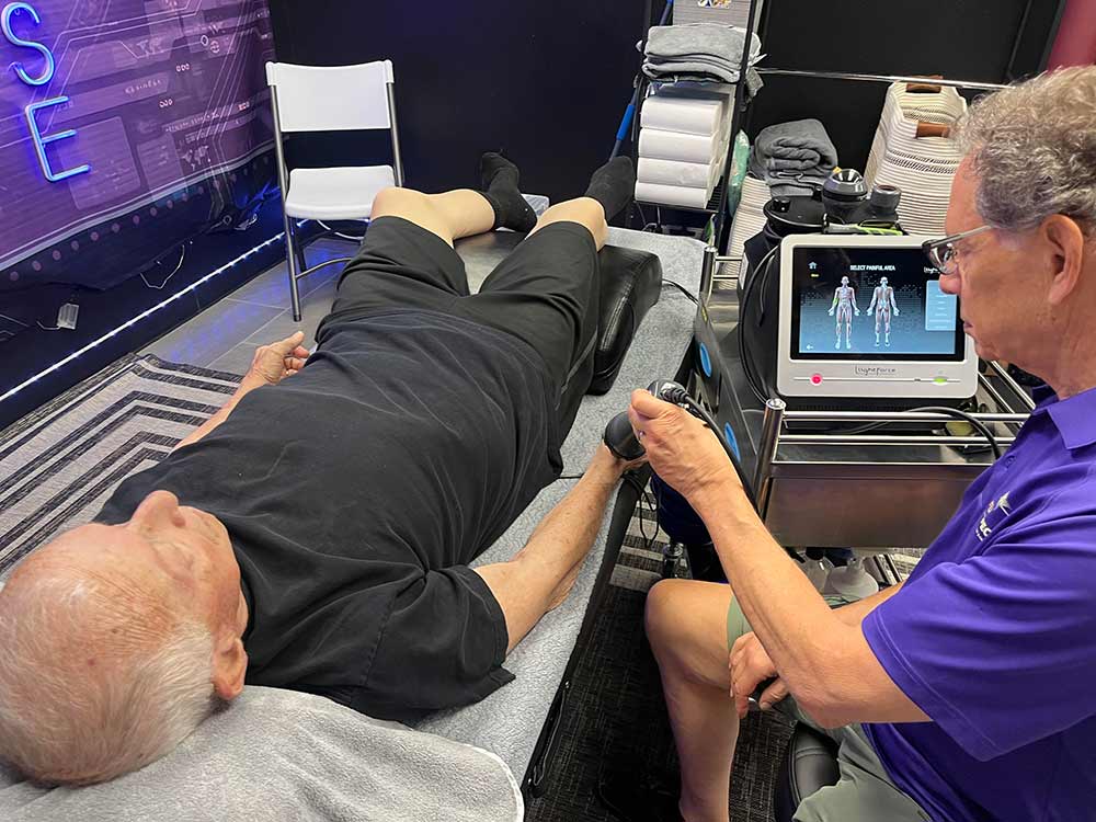 Patient receiving deep tissue laser therapy for osteoarthritis pain in the wrist and hand at Full Spectrum Therapy in Folsom, CA.